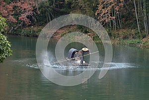 Fishman rowing boat in China river