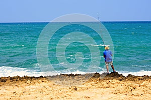 Fishmen is fishing on the sea in Greek beach