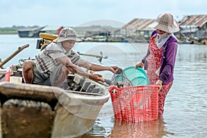 Fishmen pickup fish from boat