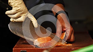 Fishmonger cutting salmon.