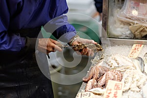 Fishmonger opens an oyster Kyoto Japan