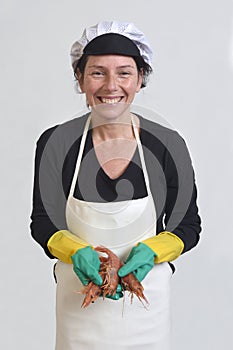 Fishmonger showing a pile of prawns on white