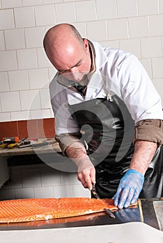 Fishmonger slicing smoked salmon, UK