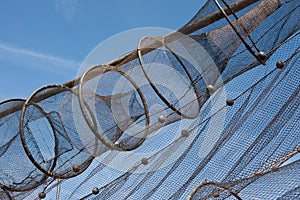 Fishnet drying in the sun against the blue sky