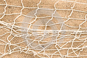 Fishnet on the sand. Fishnet. Woven mesh texture