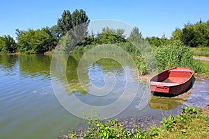 Fishpond with red boat photo