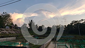 Fishponds and a Sunset Sky with Clouds