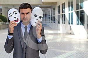 Fishy businessman holding scary masks isolated