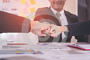 Fist bump in business meeting for team concept