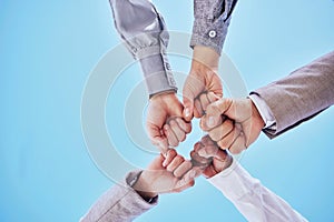 Fist bump, celebrate and business team hands winning together due to support, unity and teamwork against a sky