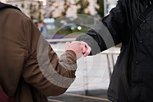 Fist bump close-up. young people say hello fist outdoors fist. respect