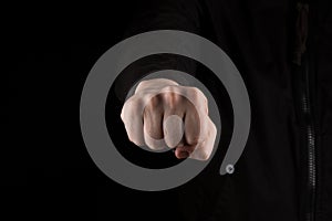 Fist Bump, a man giving a friendly fist bump. isolated on black background