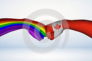 Fist bump of the rainbow LGBTQ+ flag and Canada flag.