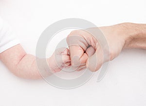 Fist of Dad and Newborn Baby. Fist to fist photo