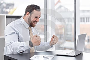 Fist pump, laptop and businessman in office with happy for winning, job promotion or career achievement. Smile