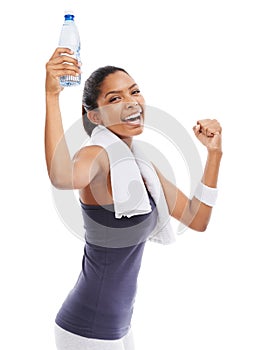 Fist pump for water. A young woman holding a bottle of water after an energizing workout.
