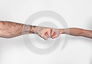 Fist to fist. Male vs female hand.  on a white background