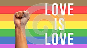 fist up with lgbt flag with text love is love in white color