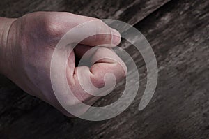 Fist on wooden background