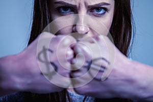 Fists of a young beautiful woman with Dollar and Euro sign as a symbol of confrontation between economics. Economy, geopolitics,