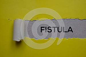Fistula Text written in torn paper. Medical concept photo