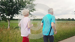Fit and active senior couple running outdoors as exercise