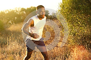 Fit african american man running outside