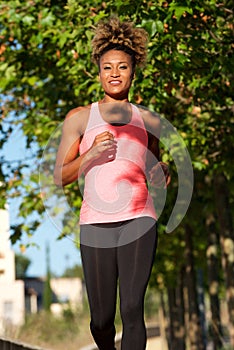 Fit african american young female jogging in morning