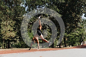 Fit athlete does cartwheel in park. Causing inspiration through outdoor training, person showcases athleticism and