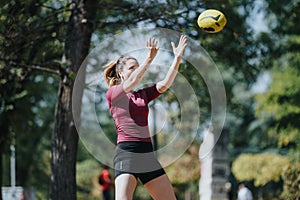 Fit and Attractive Athletes Exercising Outdoors in Park with Rugby Ball on Sunny Day