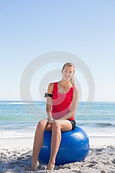 Fit blonde sitting on exercise ball