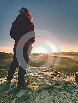 Fit body blond hair woman on the top of the high rock