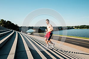 Fit Caucasian Man Running Up Steps Early Morning Workout