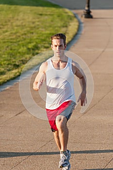 Fit Caucasian Man Spinting During An Early Morning Workout