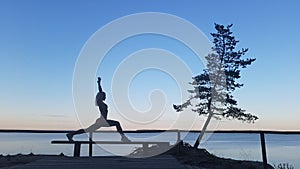 Fit caucasian woman practicing yoga outside