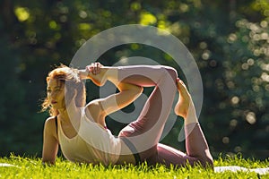 Fit caucasian woman stretching in a summer park