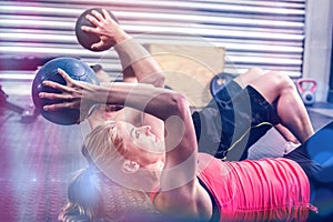 Fit couple doing abdominal ball exercise