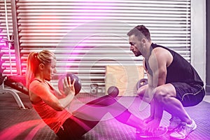 Fit couple doing abdominal ball exercise