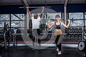 Fit couple exercising with barebell