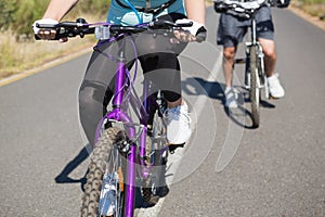 Fit couple going for a bike ride in the countryside