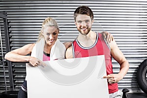 Fit couple holding blank paper