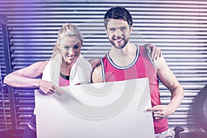 Fit couple holding blank paper