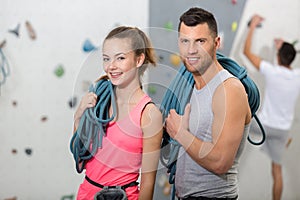 fit couple rock climbing indoors at gym