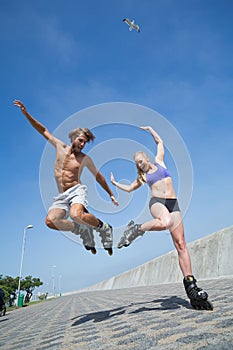 Fit couple rollerblading together on the promenade