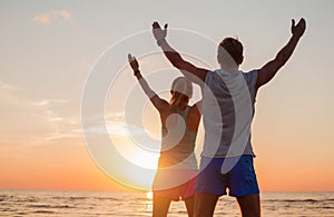 Fit couple with their hands up