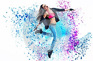 Fit dancer jumping into the paint splash