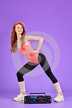 Fit female model with red hair posing for fitness club advertisment