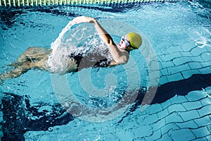 Fit female swimmer doing the back stroke