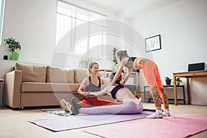 Fit females exercising and stretching at home