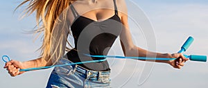 Fit fitness girl measuring her waistline with measure tape. Athletic slim woman measuring her waist by measure tape photo